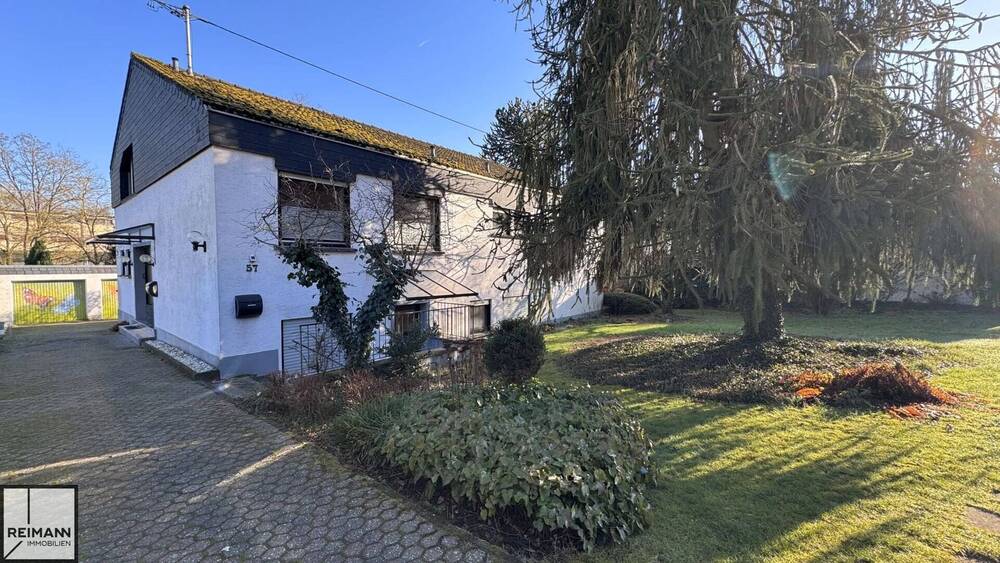 Thumbnail-Freistehendes Einfamilienhaus mit Einliegerwohnung, Doppelgarage und parkähnlichem Garten